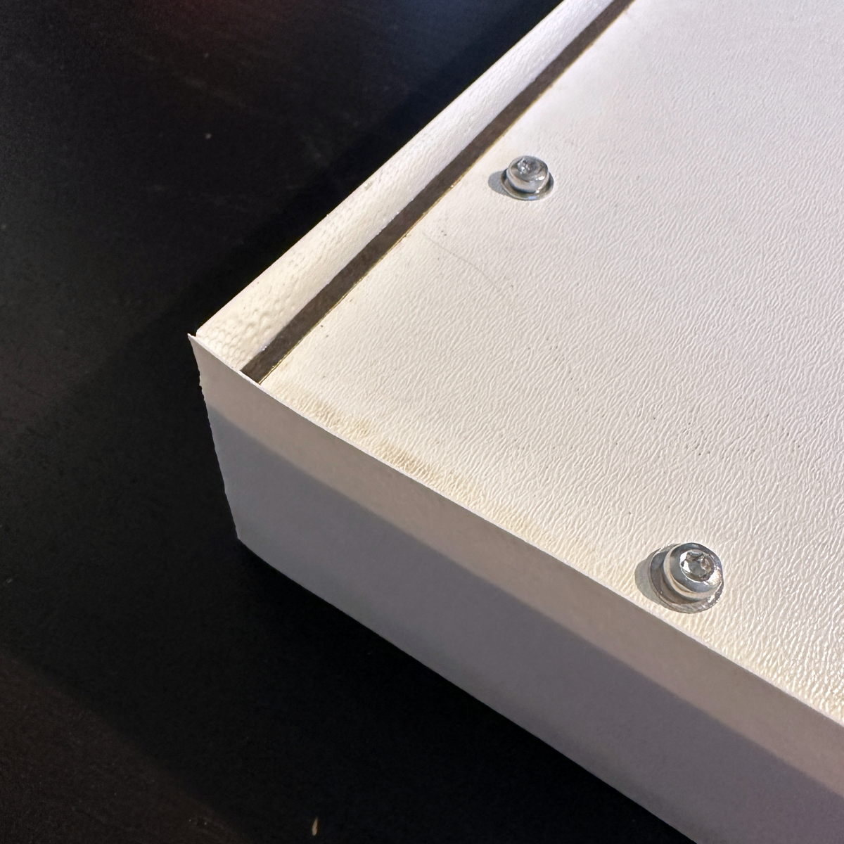 Edge band applied before cutting of excess.